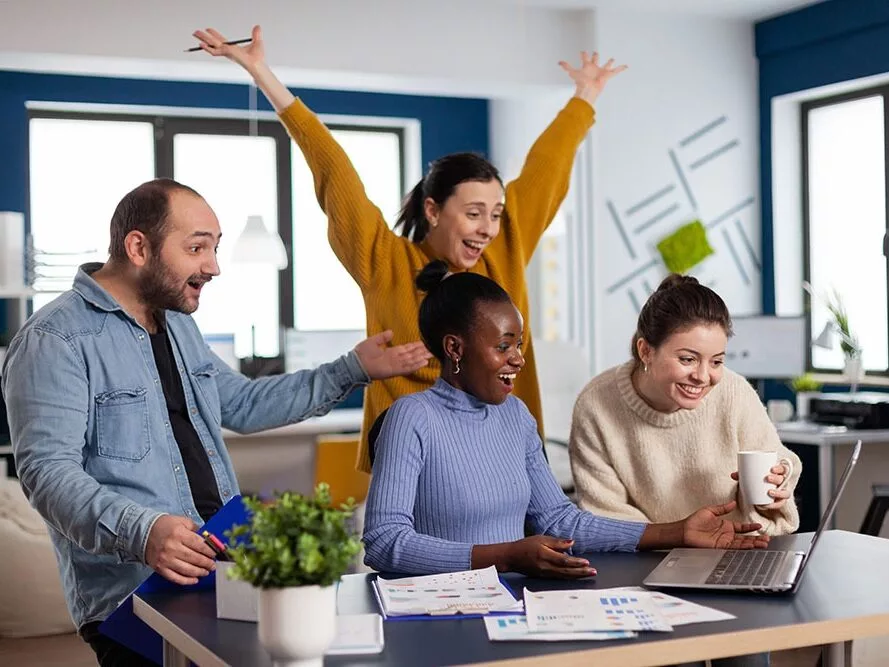 Young diverse group of entrepreneurs with hands up looking surprised
