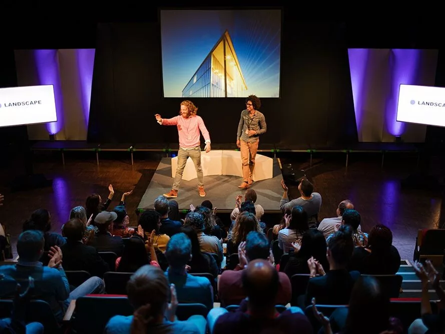 Audience watching speakers talking on stage