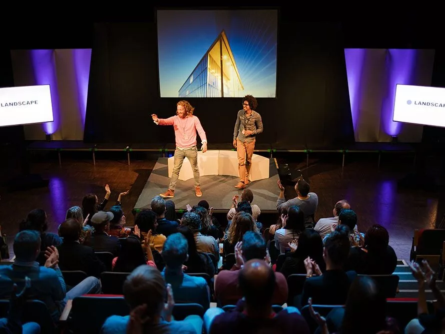 Audience watching speakers talking on stage
